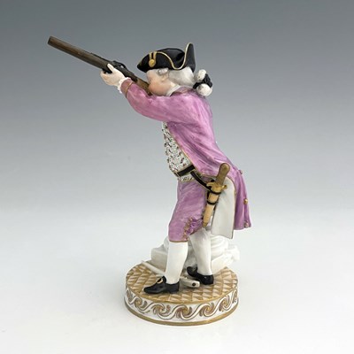 Lot 810 - A Meissen figure of a hunter firing a shotgun,...