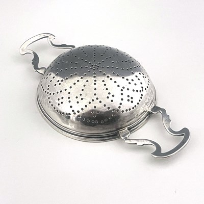 Lot 157 - A George II silver lemon strainer, the rounded...