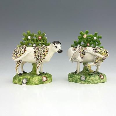 Lot 1008 - A pair of spongeware decorated figures of cows...