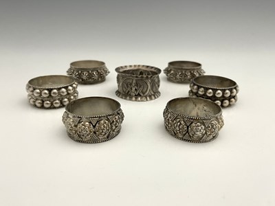 Lot 209 - A group of seven silver coloured metal napkin...