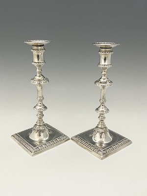 Lot 124 - A pair of George III silver cast candlesticks,...