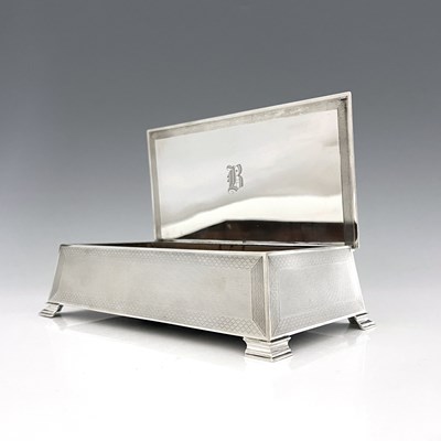 Lot 128 - A George VI silver cigarette box, in the Art...