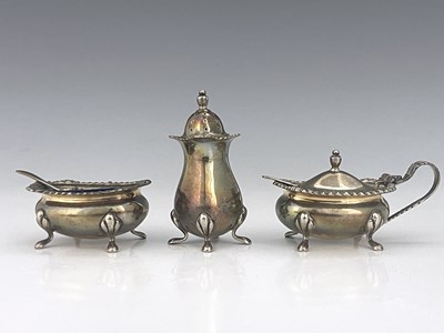 Lot 394 - An Elizabeth II silver three-piece condiment...