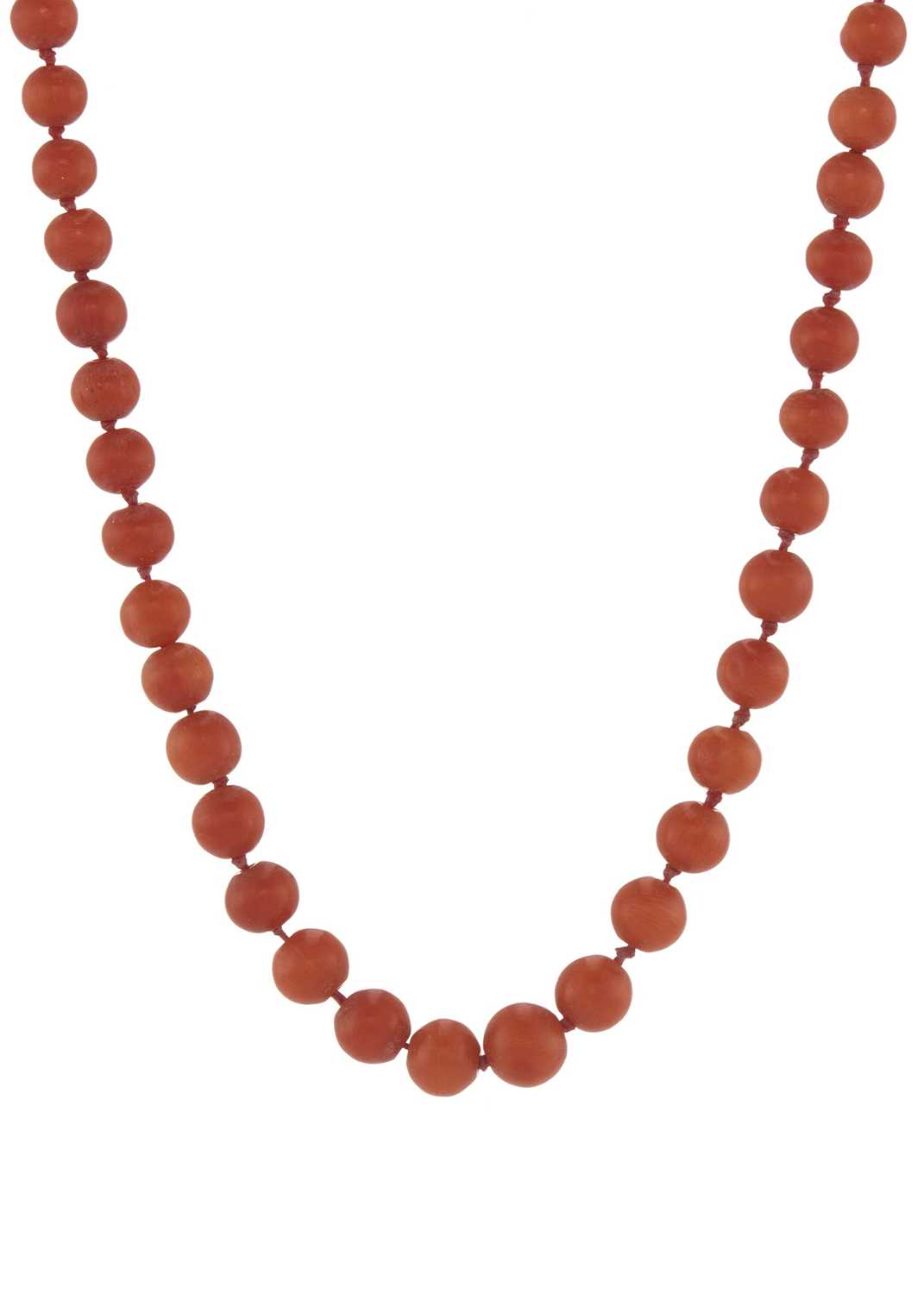 Lot 12 - An early 20th century coral single-strand necklace, with gold clasp