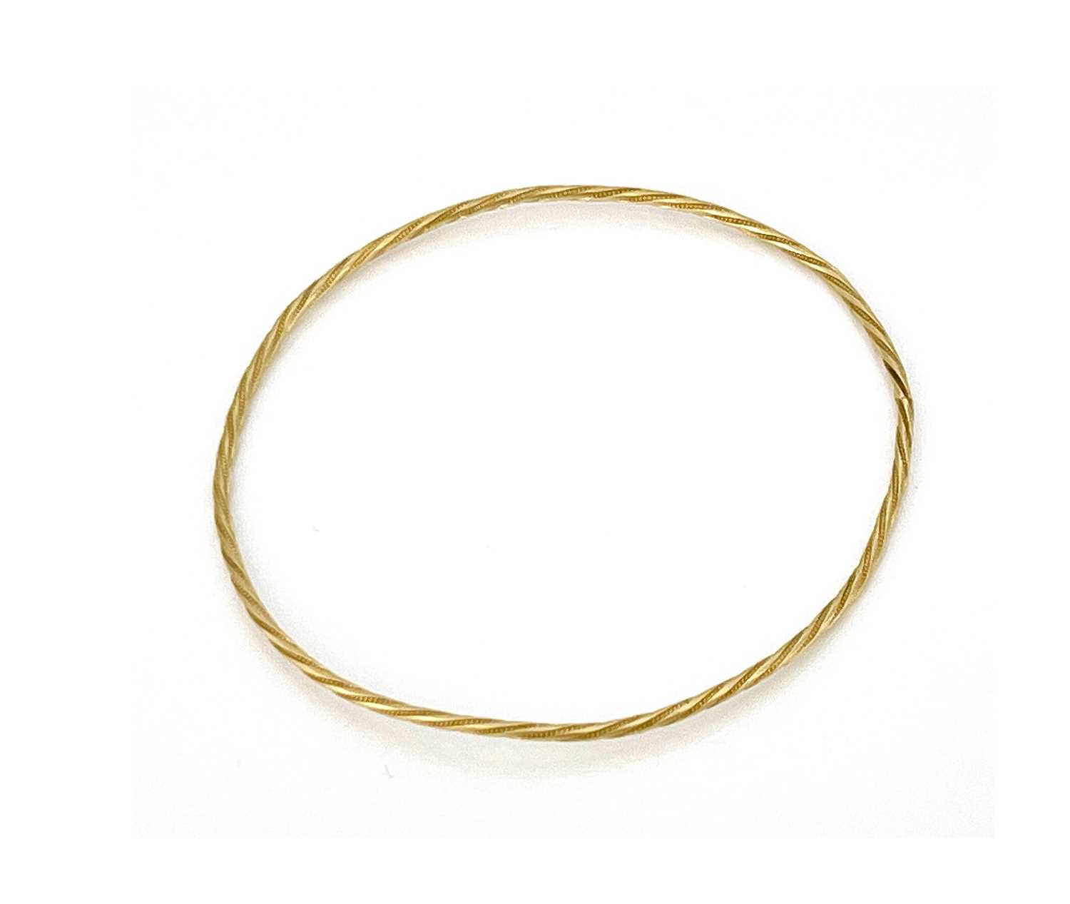 Lot 22 - A Yellow metal bangle bracelet, twisted wire...