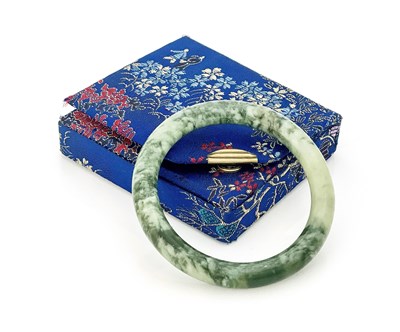 Lot 13 - A Chinese green jade bangle bracelet, moss...