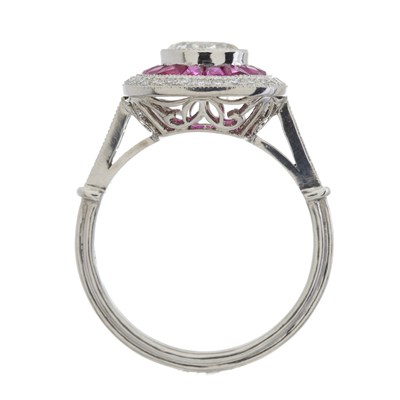 Lot 47 - A platinum diamond and ruby cluster dress ring