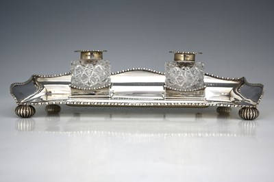 Lot 394 - A George V silver two bottle inkstand, or...