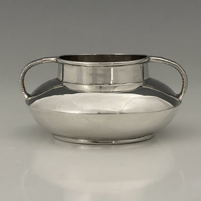 Lot 214 - An Arts and Crafts silver twin handled bowl,...