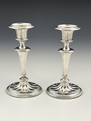 Lot 48 - A pair of Edwardian silver candlesticks,...