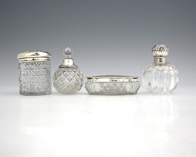 Lot 371 - Four silver-topped glass vessels, to include...