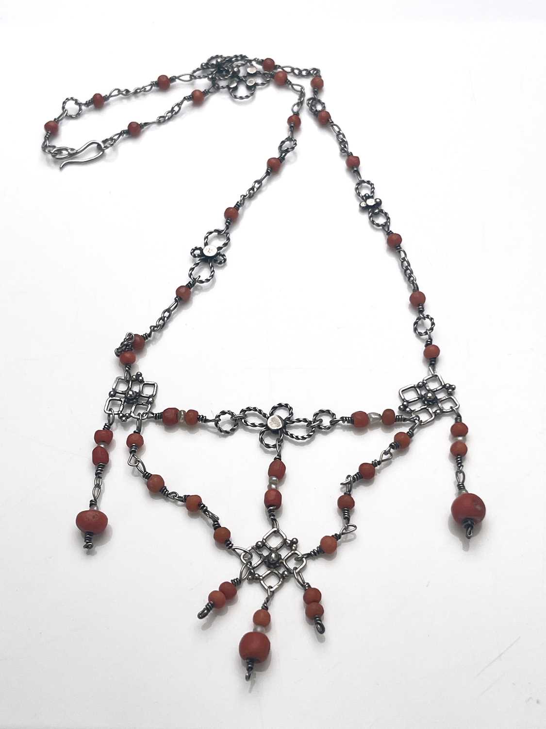 Lot 37 - An Arts and Crafts silver and coral necklace,...