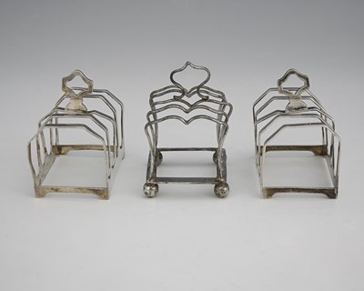 Lot 385 - A pair George V silver Art Deco toast racks,...