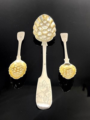 Lot 61 - Three silver berry spoons, George III and...