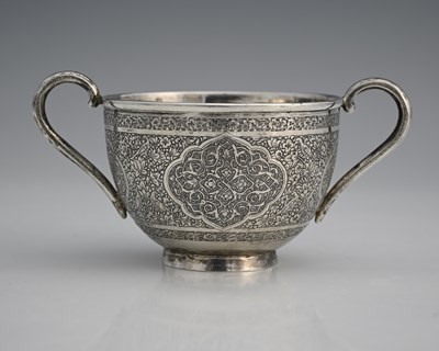 Lot 274 - A Persian silver-coloured metal twin-handled...