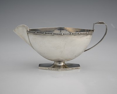 Lot 275 - A George VI Art Deco style silver sauce boat,...