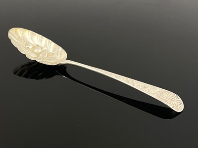 Lot 97 - A George III silver berry spoon, Alice and...