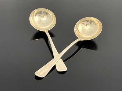 Lot 99 - A pair of George V silver sauce ladles, D and...