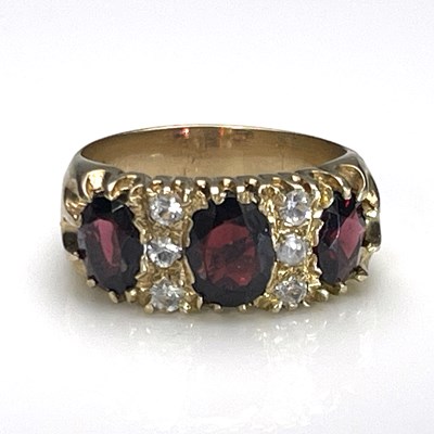 Lot 21 - A 9 carat gold and garnet ring, two rows of...