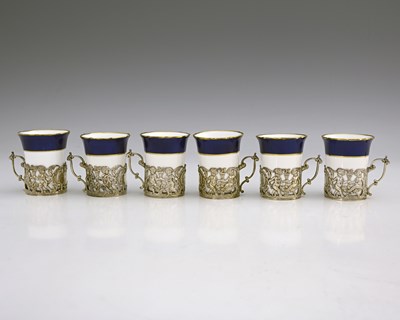 Lot 341 - A set of six Edwardian silver-mounted ceramic...