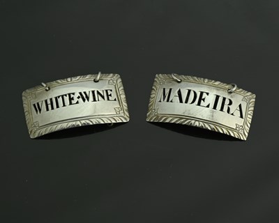 Lot 247 - A pair of George III silver wine labels or...