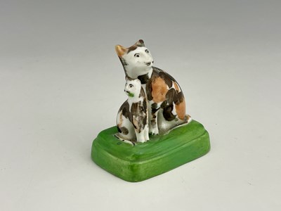 Lot 727 - A Staffordshire porcelain cat and kitten...