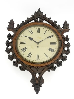 Lot 336 - A Gothic Revival carved oak wall clock, in the...