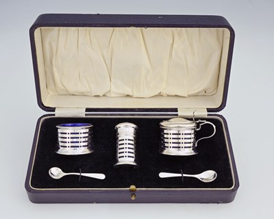 Lot 220 - A George V cased silver condiment set,...