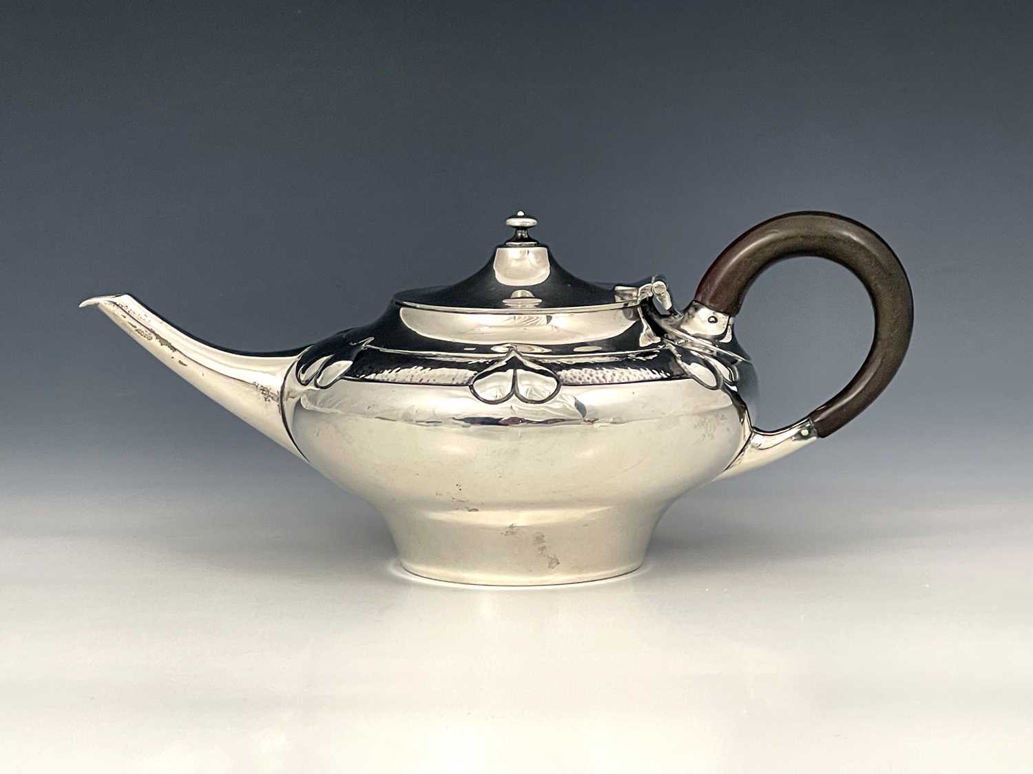 Lot 206 - A E Jones, an Arts and Crafts silver teapot,...