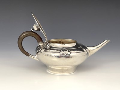 Lot 206 - A E Jones, an Arts and Crafts silver teapot,...