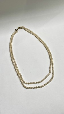 Lot 656 - A cultured pearl two-row necklace, with 9ct gold clasp