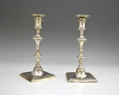 Lot 187 - A pair of George III silver cast candlesticks,...