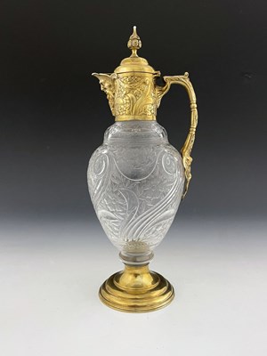 Lot 334 - A Victorian silver-gilt mounted claret jug,...