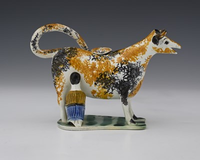 Lot 593 - An early 19th Century Prattware cow creamer...