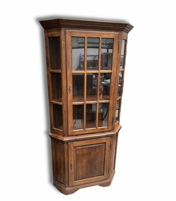 Lot 891 - A stained oak corner display unit, the upper...