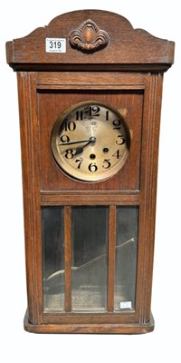 Lot 347 - A mid 20th Century oak cased wall clock,...