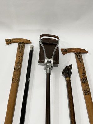 Lot 568 - Walking Sticks: an ebonised wood cane with...