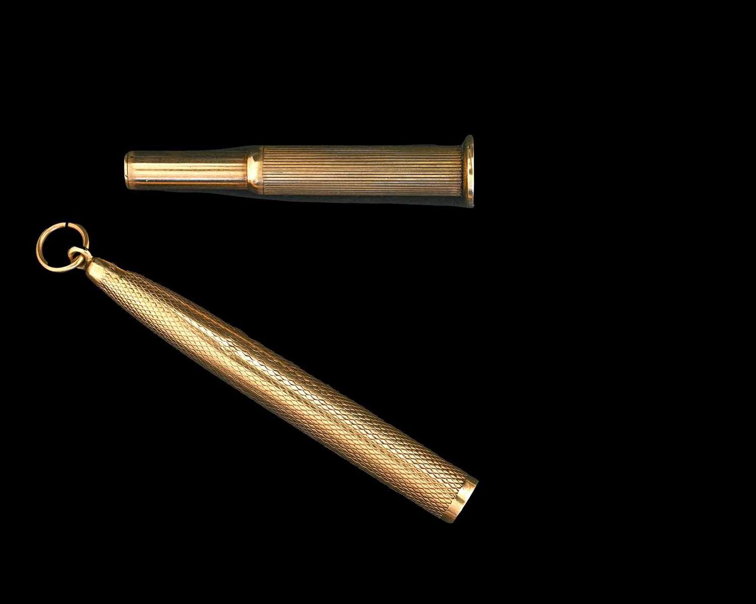 Lot 28 - A nine-carat gold engine turned cigar piercer,