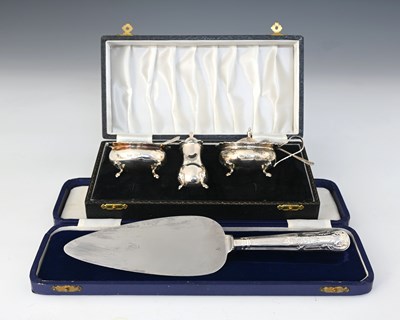 Lot 250 - An Elizabeth II silver three-piece cased cruet...