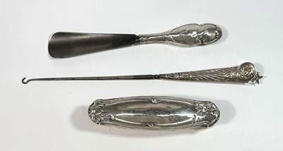 Lot 705 - An Asprey silver handled button hook with...