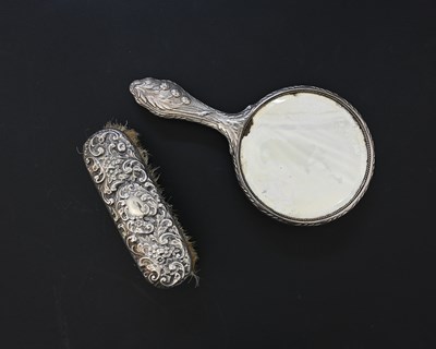 Lot 260 - An Edwardian silver-mounted hand mirror, in...