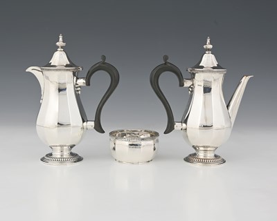 Lot 366 - Asprey. A George V silver three-piece cafe au...