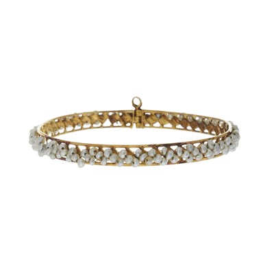 Lot 128 - An 18ct gold pearl bangle bracelet