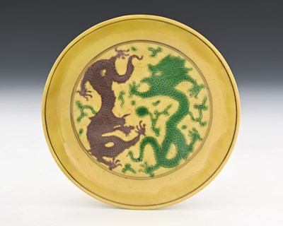 Lot 401 - A Chinese famille jaune dish, Kangxi mark,...