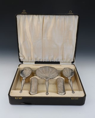 Lot 153 - A George V silver cased dressing table set,...