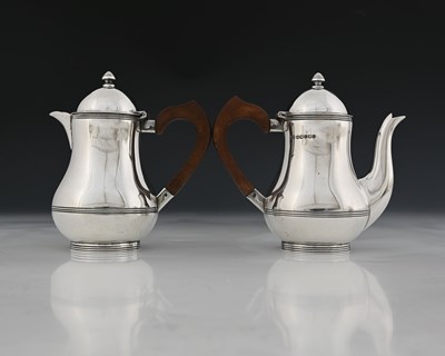 Lot 143 - A pair of George V silver cafe au lait pots,...