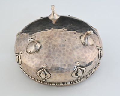 Lot 142 - An Arts and Crafts silver swing handled bowl,...