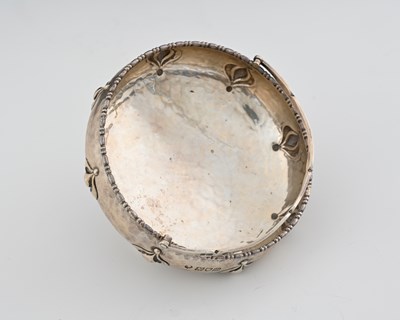 Lot 142 - An Arts and Crafts silver swing handled bowl,...