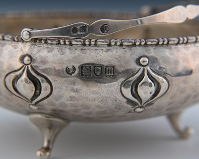 Lot 142 - An Arts and Crafts silver swing handled bowl,...
