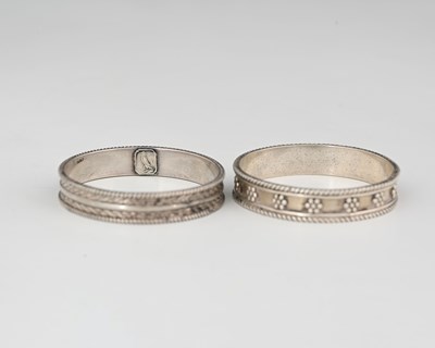 Lot 154 - H G Murphy, two Arts and Crafts silver napkin...